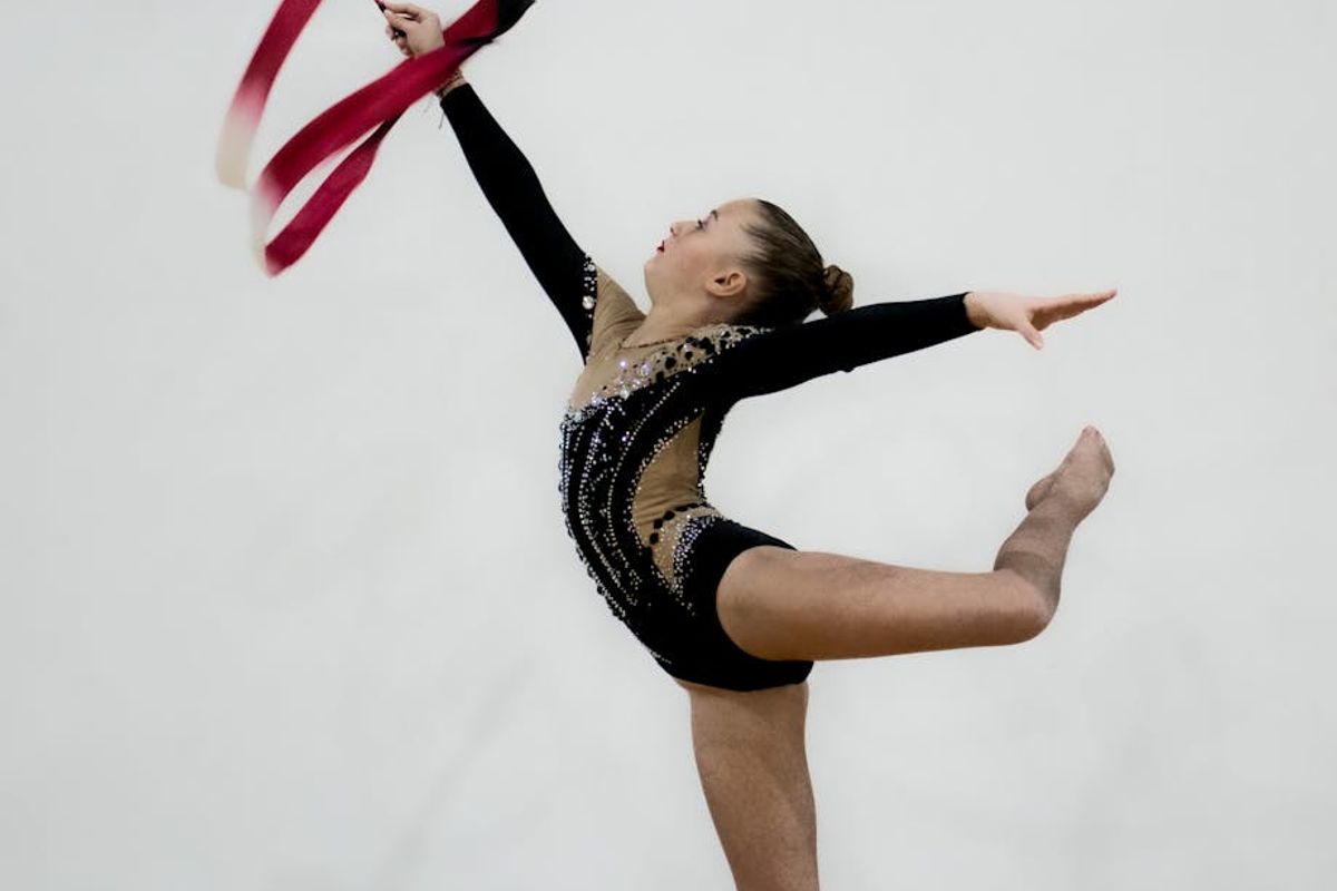 Athletic person doing rhythmic movements in a dark studio