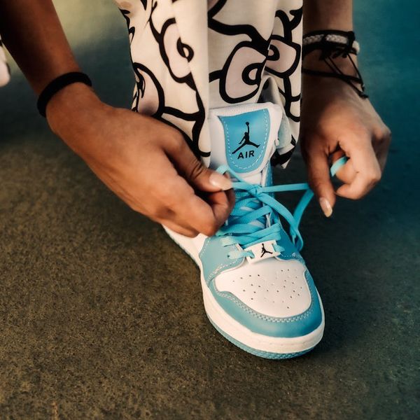 Detail of a person hands tying athletic shoes