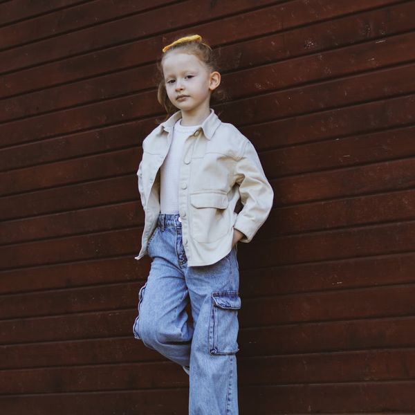 Person standing in a balance pose against light wall